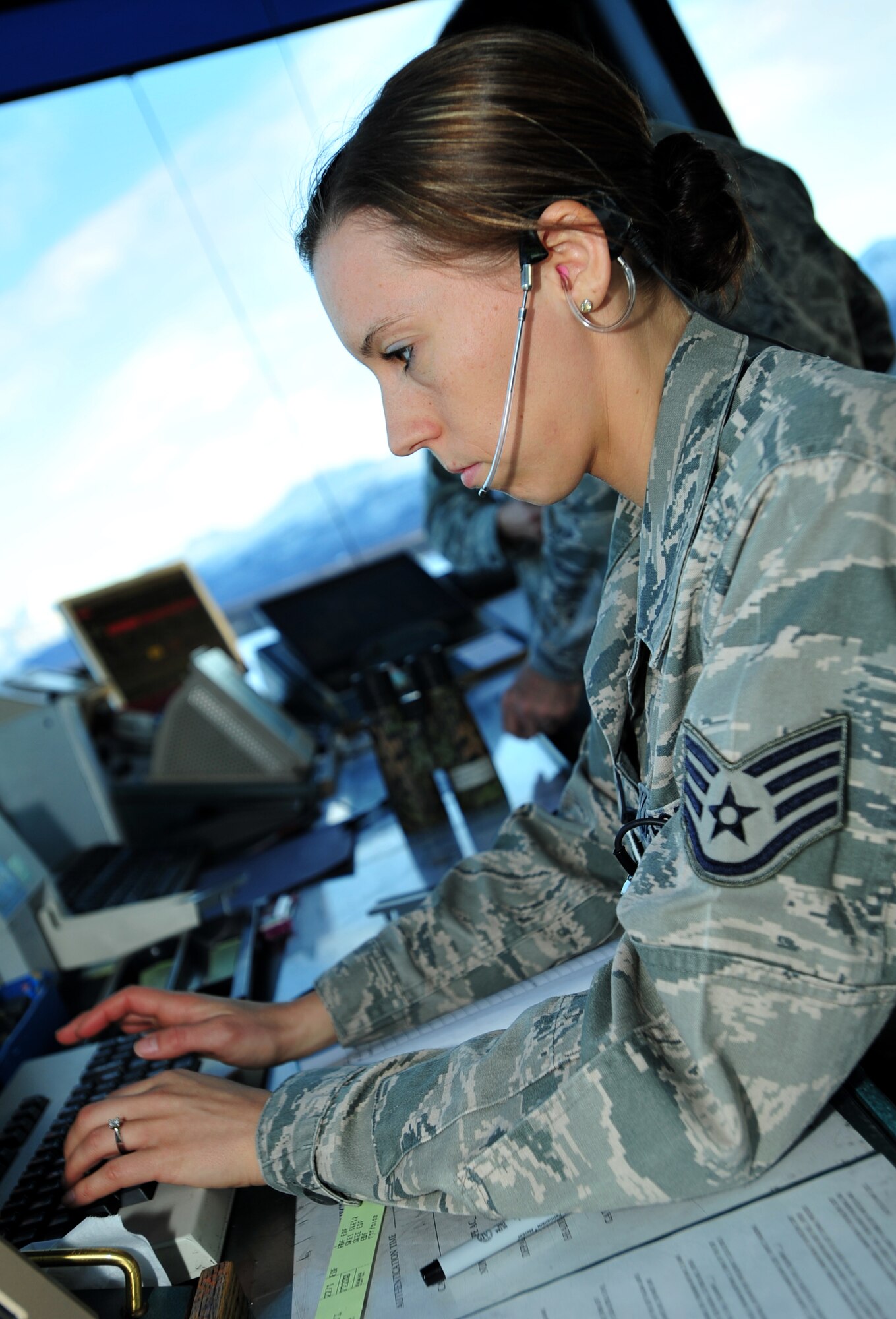 Staff Sgt. Candice Chase inputs the flight plans of multiple aircraft Dec. 21 at Joint Base Elmendorf-Richardson, Alaska. JBER's air traffic controllers handle an average of 150 flights daily to include directing the movement of aircraft into and out of the military airfields, relay flights and landing instructions, weather reports and safety informations to pilots. Chase is assigned to the 3rd Operations Support Squadron. (U.S. Air Force photo/Staff Sgt. Sheila deVera)

 
