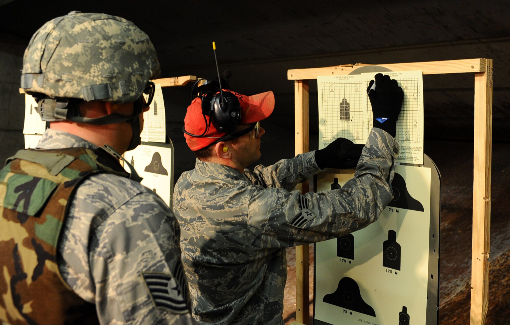 Senior Airman Nathan Warren, 28th Security Forces Squadron combat arms instructor, tallies up the score for an Airman during a 28th SFS Combat Arms Training and Maintenance rifle course on Ellsworth Air Force Base, S.D., Jan. 9, 2012. The scores are added up to determine an Airman’s accuracy and proficiency on the weapon system, and meet their deployment qualification requirements. (U.S. Air Force photo by Airman 1st Class Zachary Hada/Released)
