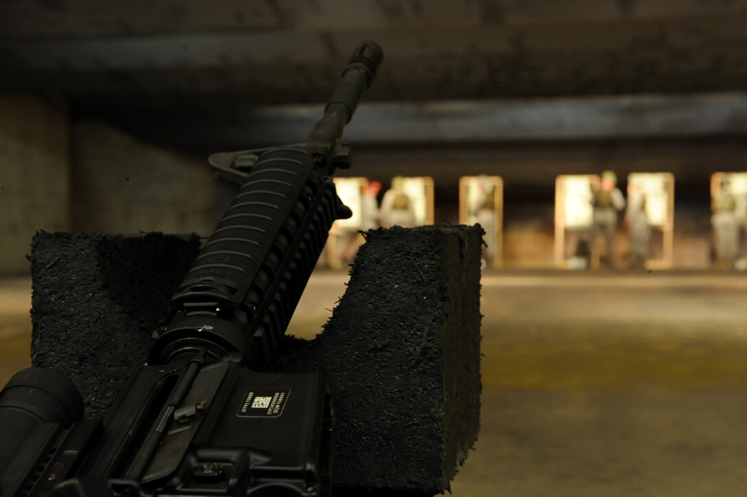 A safely cleared M4 rifle rests silently while Airmen check and evaluate the accuracy of their fire during a 28th Security Forces Squadron Combat Arms Training and Maintenance rifle course on Ellsworth Air Force Base, S.D., Jan. 9, 2011. Airmen gain proficiency with the weapons by firing rounds at targets in different positions. (U.S. Air Force photo by Airman 1st Class Zachary Hada/Released)