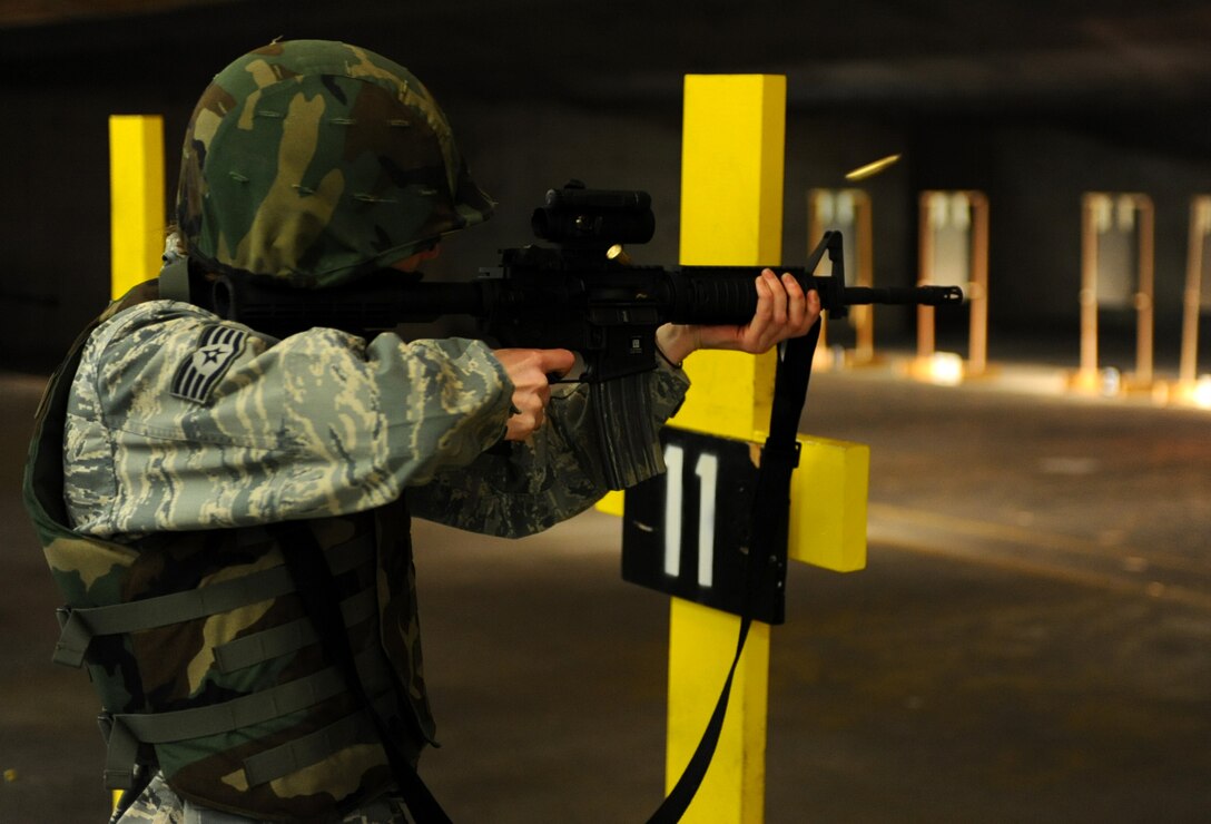 Staff Sgt. Tiffany Brown, 28th Force Support Squadron food service craftsman, fires rounds at the 28th Security Forces Squadron Combat Arms Training and Maintenance rifle range during pre-deployment training on Ellsworth Air Force Base, S.D., Jan. 9, 2012. The new rifle course includes real-world scenarios to make Airmen more proficient in close-quarter combat situations such as rounding corners and shooting while moving. (U.S. Air Force photo by Airman 1st Class Zachary Hada/Released)
