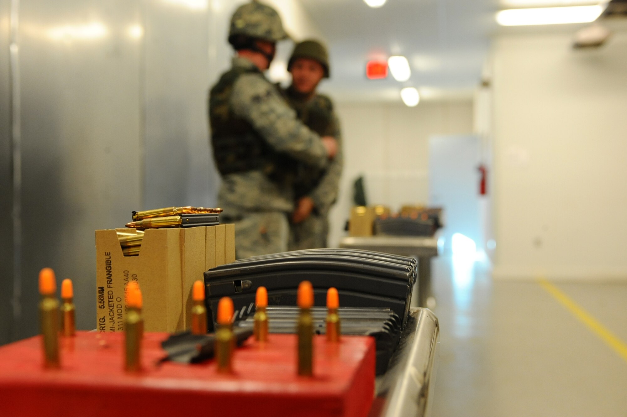Airmen prepare for the 28th Security Forces Squadron Combat Arms Training and Maintenance rifle course during pre-deployment training on Ellsworth Air Force Base, S.D., Jan. 9, 2012. Airmen practice with both live 5.56 mm ammunition and 5.56 mm dummy rounds as a way to increase their proficiency and accuracy during the firing exercise. (U.S. Air Force photo by Airman 1st Class Zachary Hada/Released) 