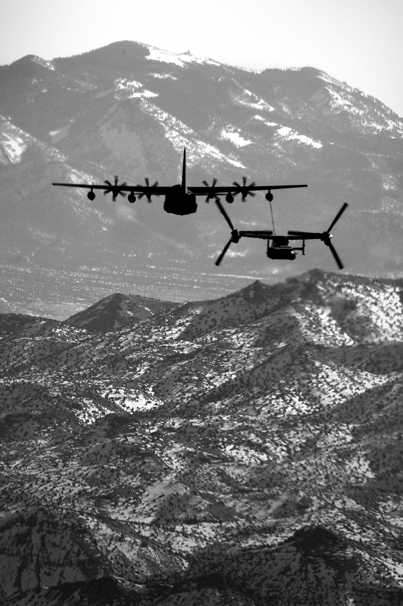 A 71st Special Operations Squadron, CV-22 Osprey, is refueled by a 522 SOS Squadron MC-130J Commando II over the skies of New Mexico, Jan. 4, 2012.  The 71 SOS is stationed at Kirtland Air Force Base, N.M., and the 522 SOS at Cannon AFB, N.M.  The MC-130J provided in-flight refueling as part of a joint-base partnership.  (U.S. Air Force photo by Senior Airman James Bell)