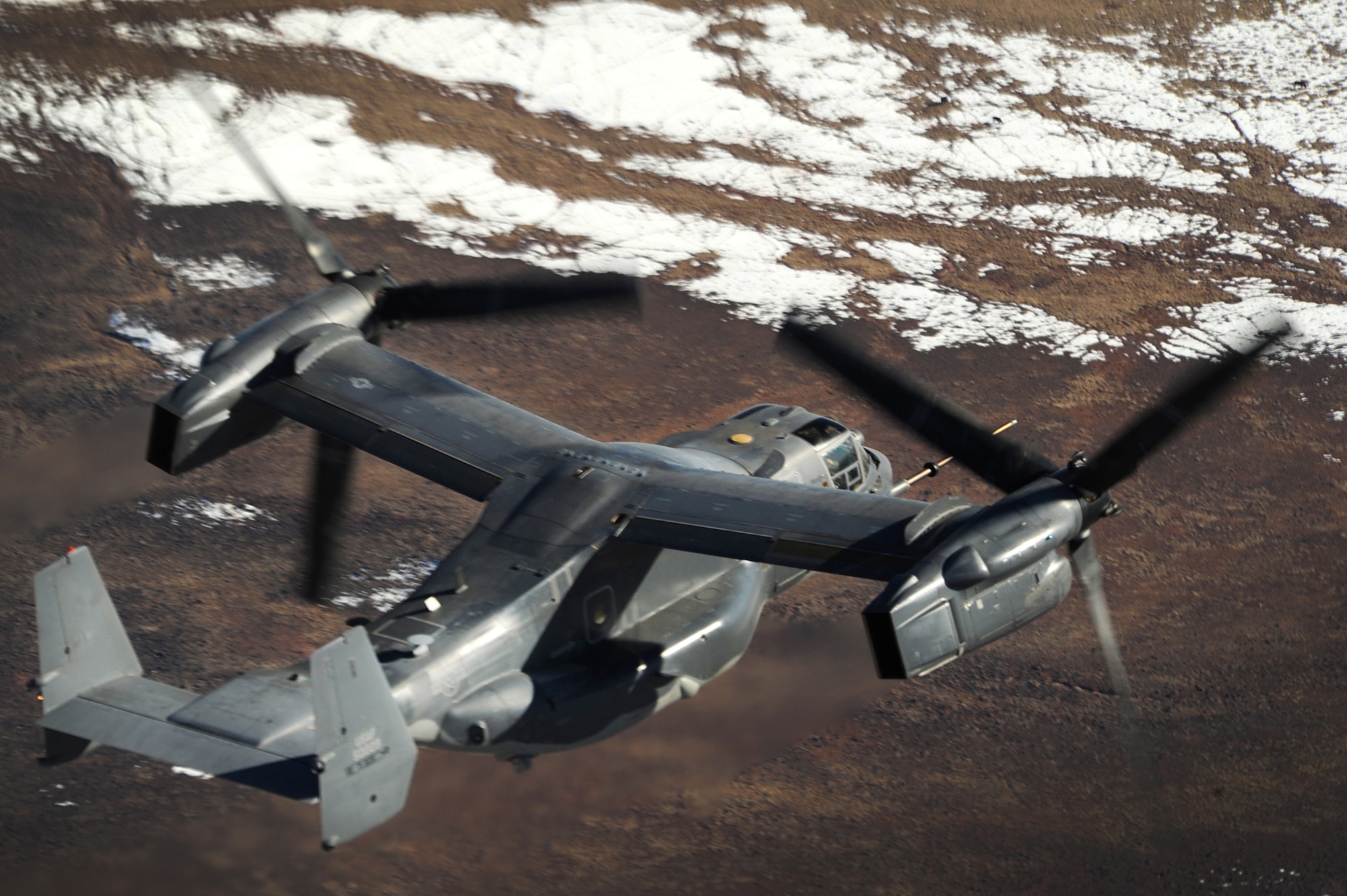 A 71st Operations Squadron CV-22 Osprey, flies over the skies of New Mexico practicing air refueling with a 522 SOS MC-130J Commando II, Jan. 4, 2012.  The 71 SOS is stationed at Kirtland Air Force Base, N.M., and the 522 SOS at Cannon AFB N.M.  (U.S. Air Force photo by Senior Airman James Bell)