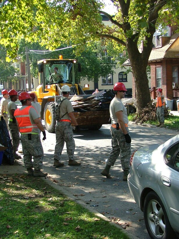 Narrow roadways and parked vehicles created an obstacle course for 201st RED HORSE Squadron heavy equipment operators tasked to remove debris Sept.
12-16, 2011 in the Harrisburg area.  Members helped with flood cleanup after a hurricane and tropical storm wreaked havoc on the tristate area. Working in narrow
confines, they hand-loaded the debris into buckets. 

The 201st RED HORSE Squadron, Detachment 1 activated 44 members to assist state and local authorities with clean-up efforts after the onslaught of devastating rains brought on by Hurricane Irene and remnants of Tropical Storm Lee. The series of storms substantially impacted the central region of Pennsylvania.
