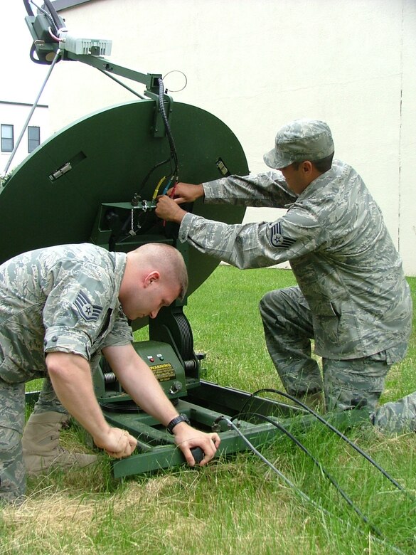 Staff Sgt. Matthew Dechant and Staff Sgt. Alexis Galatis, cyber transport specialists,
level and target the Joint Incident Site Communication Capability, or JISCC, dish.
Relaying data via satellite allows select agencies to access information regardless
of distance from the incident sight. Team members of the 111th Communications Flight set up their mobile communication hub on Jun. 4, 2011 to run personnel through the steps of its set-up and operation, which is required on a reoccurring basis. 

The Joint Incident Site Communication Capability (JISCC) kit offers a unique dimension of connection and information transfer. The demand for real time crisis management communications for federal, state and local authorities increases at the speed of technology.