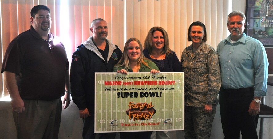 (Left to Right) Andy Pauley, 9th Force Support Squadron Community Services flight chief, Maj. (Ret.) Kerry Adams, Taryn Adams, Heather Adams, Maj. Connie May, 9th FSS commander, and Ray Woodbeck, 9th FSS Recce Point Club manager. Heather Adams recently won an all expenses paid trip to the 2012 Super Bowl in Indianapolis as part of the Air Force Club's Football Frenzy promotion. Adams is the second consecutive Super Bowl winner from Beale. (U.S. Air Force photo by Senior Airman Chuck Broadway/Released)