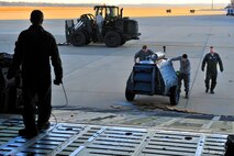 U.S. Air Force Tech. Sgt. Devin Paskewich, 436th Aircraft Maintenance Squadron crew chief, guides cargo on a C-5 Galaxy at Shaw Air Force Base S.C., Jan. 6, 2012. Paskewich worked with Shaw Airmen and other crew chiefs to load aerospace ground equipment and other cargo for transport overseas in support of a deployment tasking. (U.S. Air Force Photo by Senior Airman Neil D. Warner/Released)