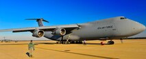 U.S. Air Force Tech. Sgt. Vicent Bustamante, 20th Logistics Readiness Squadron deployment instructor, observes a C-5 Galaxy aircraft as it taxes on the flightline, Jan. 6, 2012. Three C-5s landed at Shaw Air Force Base S.C., over a three-day period to pick up Airmen and supplies in support of a deployment tasking. (U.S. Air Force Photo by Senior Airman Neil D. Warner/Released)