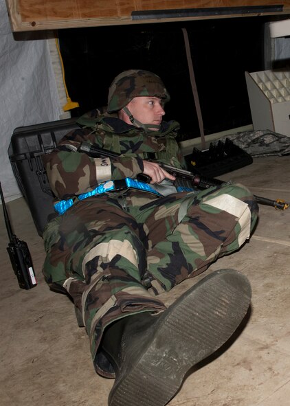 U.S. Air Force Tech. Sgt. Craig Lancaster, 23rd Civil Engineer Squadron, takes shelter in a bunker after a simulated attack during a phase II operational readiness exercise held at the field training exercise site Jan. 11, 2012, at Moody Air Force Base, Ga. The ability of Moody Airmen to take the necessary actions during a real-world attack will be challenged during the upcoming¬ operational readiness inspection. (U.S. Air Force photo by Senior Airman Eileen Meier/Released)