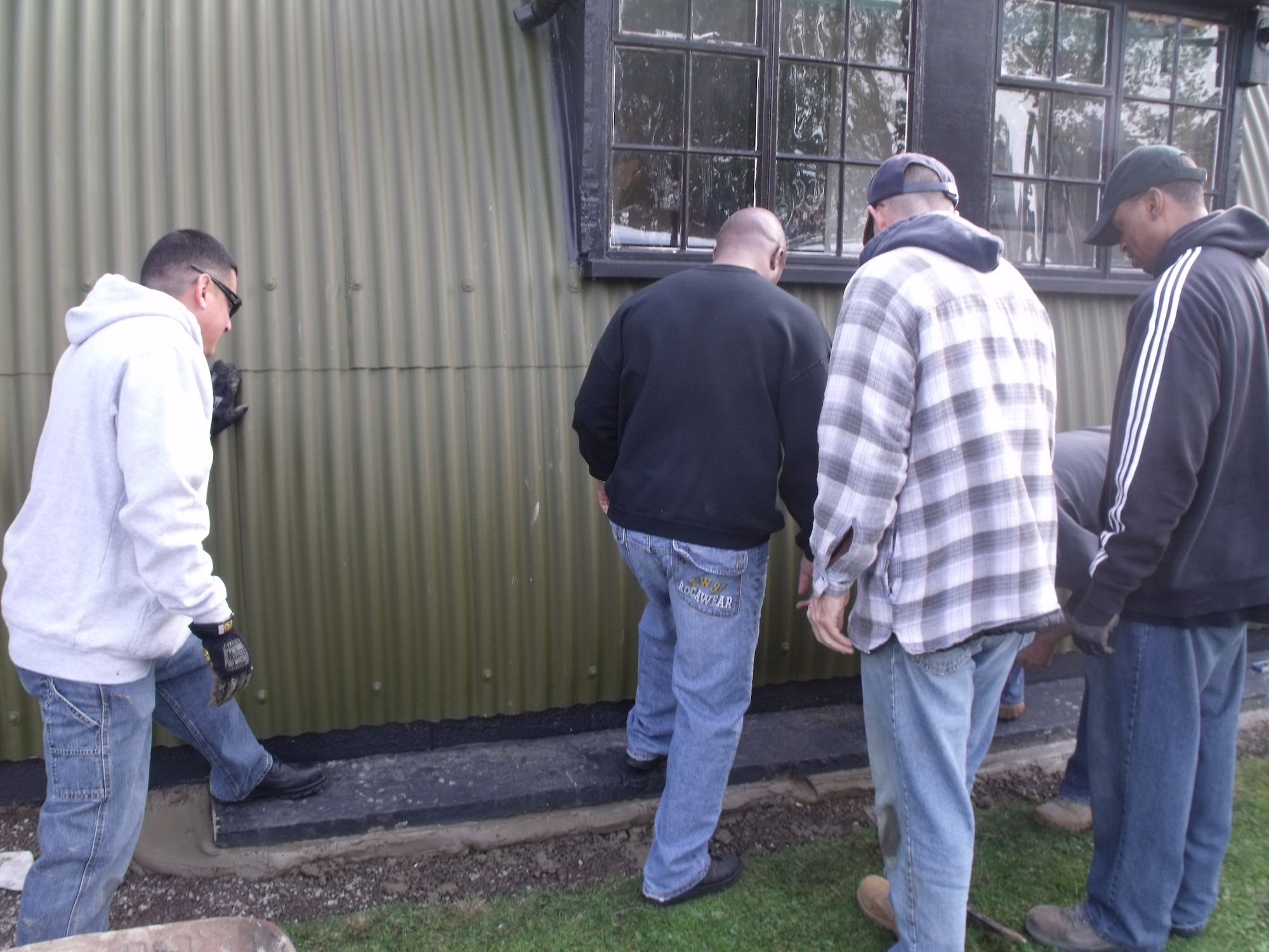 RAF MILDENHALL, England – Volunteers from the 100th Civil Engineer Squadron Top-4, lay a new foundation at the 100th Bomb Group Memorial Museum visitor center, Thorpe Abbots, England, October 2011. The 100th CES Top-4, a group made up of enlisted leaders being in the ranks of technical sergeant through chief master sergeant, adopted the museum and volunteer to assist the museum with maintenance and small construction projects. (Courtesy photo)