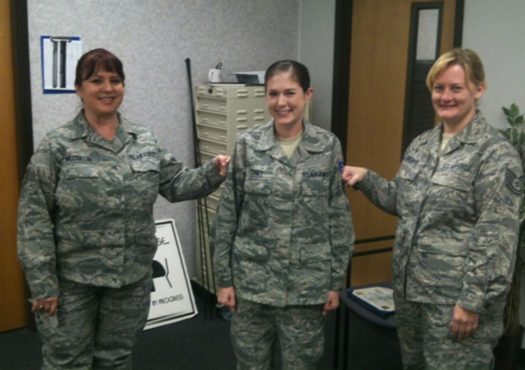 Reservist Shelly Toney (center) is promoted to the rank of staff sergeant by Master Sgt. Jill Weissflog (left) and Tech. Sgt. Kim Browne (right) during the January drill weekend. All three are members of the 916th Force Support Squadron. (USAF photo courtesy of 916FSS)