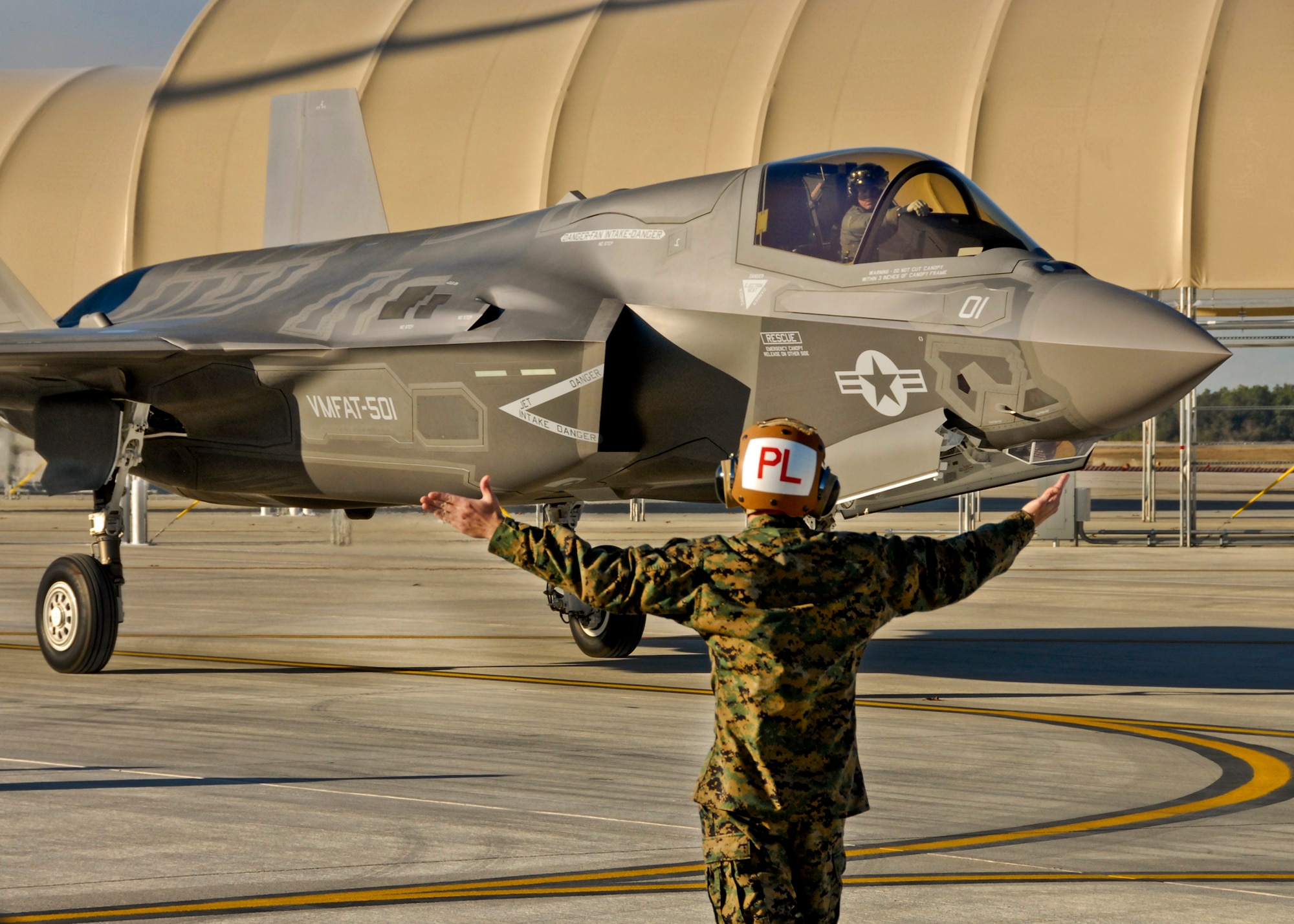 Gunnery Sgt. Matthew Smith, a maintainer with Marine Fighter Attack Squadron 501, marshals in the first Marine variant F-35B Lightning II joint strike fighter to arrive at Eglin Air Force Base, Fla., Jan. 11.  (U.S. Air Force photo/Chrissy Cuttita)