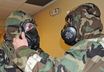 Master Sgt. Travis Birks performs a buddy check on Tech Sgt. Matthew Prechtel, during a chemical, biological, radiological and nuclear class at Seymour Johnson Air Force Base, N.C., Jan. 9, 2012. Birks is a 4th Equipment Maintenance Squadron conventional maintenance non commissioned officer in charge who hails from Miami.  Prechtel is a 4th Equipment Maintenance Squadron conventional maintenance supervisor who hails from Jasper, Ind. (U.S. Air Force photo/Senior Airman Gino Reyes)