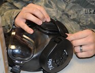 Staff Sgt. Phillip Krier inspects his M-50 gas mask during a chemical, biological, radiological, nuclear and explosive class at Seymour Johnson Air Force Base, N.C., Jan. 9, 2012. The class familiarizes with Airmen how to properly inspect, clean and wear the M-50 mask. Krier is a 4th Equipment Maintenance Squadron aircraft structural maintenance technician who hails from Tulsa, Okla. (U.S. Air Force photo/Senior Airman Gino Reyes)