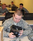Staff Sgt. Phillip Krier inspects his M-50 gas mask during a chemical, biological, radiological, nuclear and explosive class at Seymour Johnson Air Force Base, N.C., Jan. 9, 2012. The CBRNE class is mandatory for Airmen slated to deploy. Krier is a 4th Equipment Maintenance Squadron aircraft structural maintenance technician who hails from Tulsa, Okla. (U.S. Air Force photo/Senior Airman Gino Reyes)