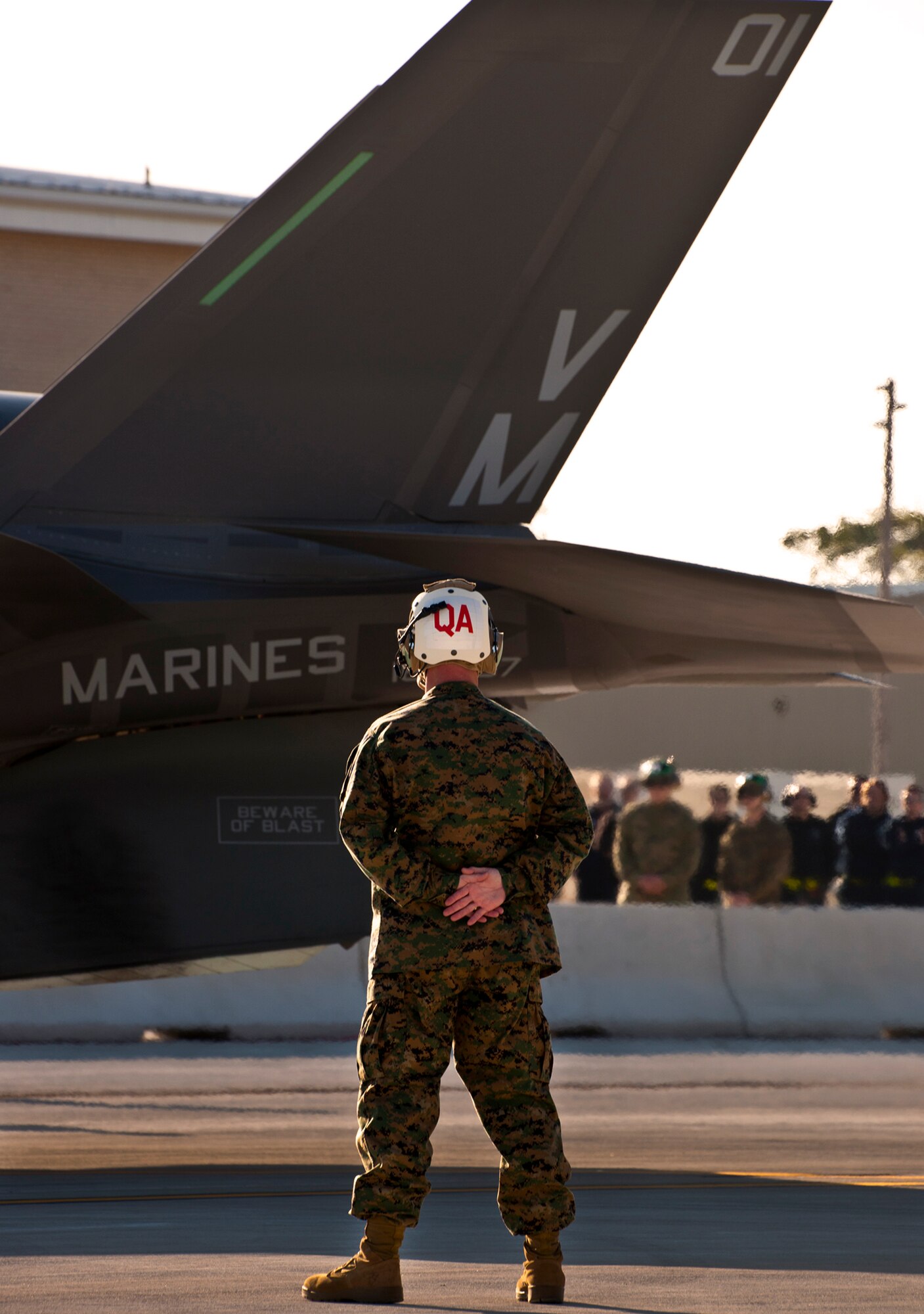 A Marine Fighter Attack Squadron 501 maintainer stands by as the first Marine variant F-35B Lightning II joint strike fighter is marshaled into place in front of the squadron at Eglin Air Force Base, Fla.  The Marines of VMFAT-501 received two F-35Bs Jan. 11.  Both aircraft were escorted in by Marine F-18 Hornets.  (U.S. Air Force photo/Samuel King Jr.)