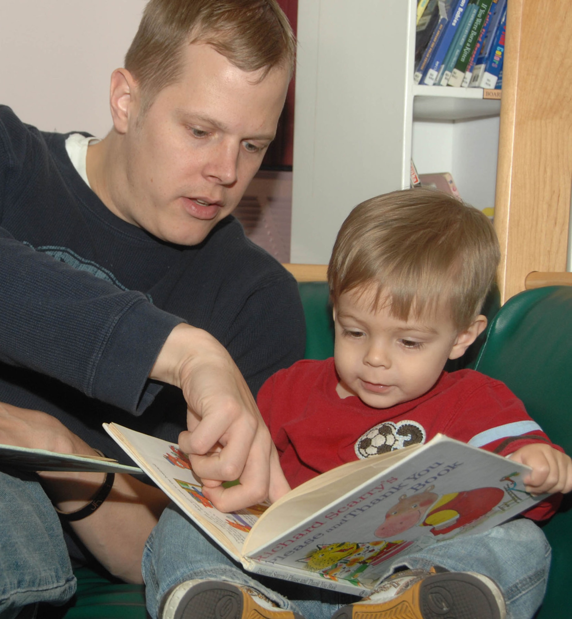 HANSCOM AIR FORCE BASE, Mass. – Benjamin Hofmann (right) and his dad, Peter, read a book together at the base library. Resources are now available for those associated with the Exceptional Family Member Program (EFMP) and include books, videos and journals. (U.S. Air Force photo by Linda LaBonte Britt)