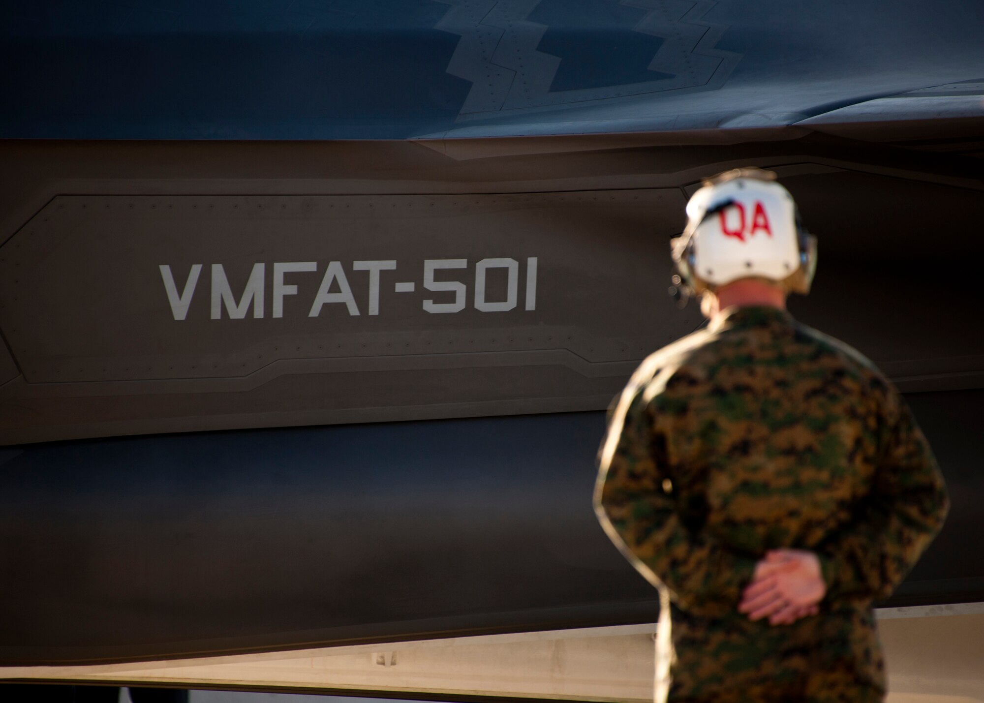 A Marine Fighter Attack Squadron 501 maintainer stands by as the first Marine variant F-35B Lightning II joint strike fighter is marshaled into place in front of the squadron at Eglin Air Force Base, Fla.  The Marines of VMFAT-501 received two F-35Bs Jan. 11.  Both aircraft were escorted in by Marine F-18 Hornets.  (U.S. Air Force photo/Samuel King Jr.)