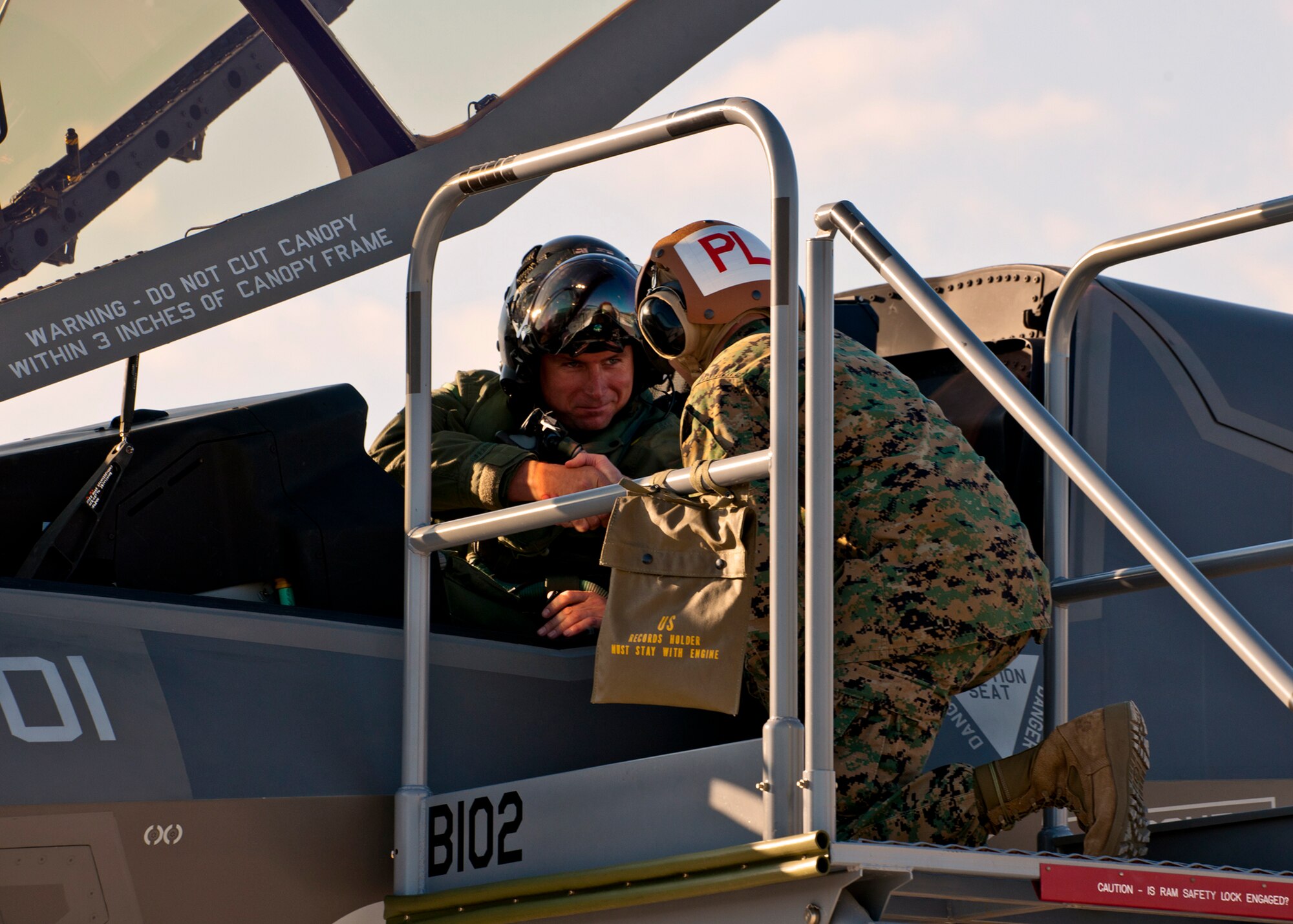 Maj. Joseph Bachmann shakes hands with his plane captain Gunnery Sgt. Matthew Smith, of Marine Fighter Attack Squadron 501, after bringing the first Marine F-35B Lightning II joint strike fighter to its new home at Eglin Air Force Base, Fla.  The Marines of VMFAT-501 received two F-35Bs Jan. 11.  Both aircraft were escorted in by Marine F-18 Hornets.  (U.S. Air Force photo/Samuel King Jr.)
