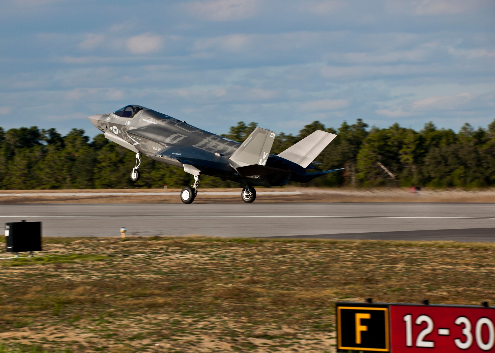 The Marine Corp’s newest aircraft, the F-35B Lightning II joint strike fighter touches down at its new home at Eglin Air Force Base, Fla.  The newest aircraft in the Department of Defense inventory belongs to Marine Fighter Attack Squadron 501. The Marines of VMFAT-501 received two F-35Bs Jan. 11.  Both aircraft were escorted in by Marine F-18 Hornets.  (U.S. Air Force photo/Samuel King Jr.)