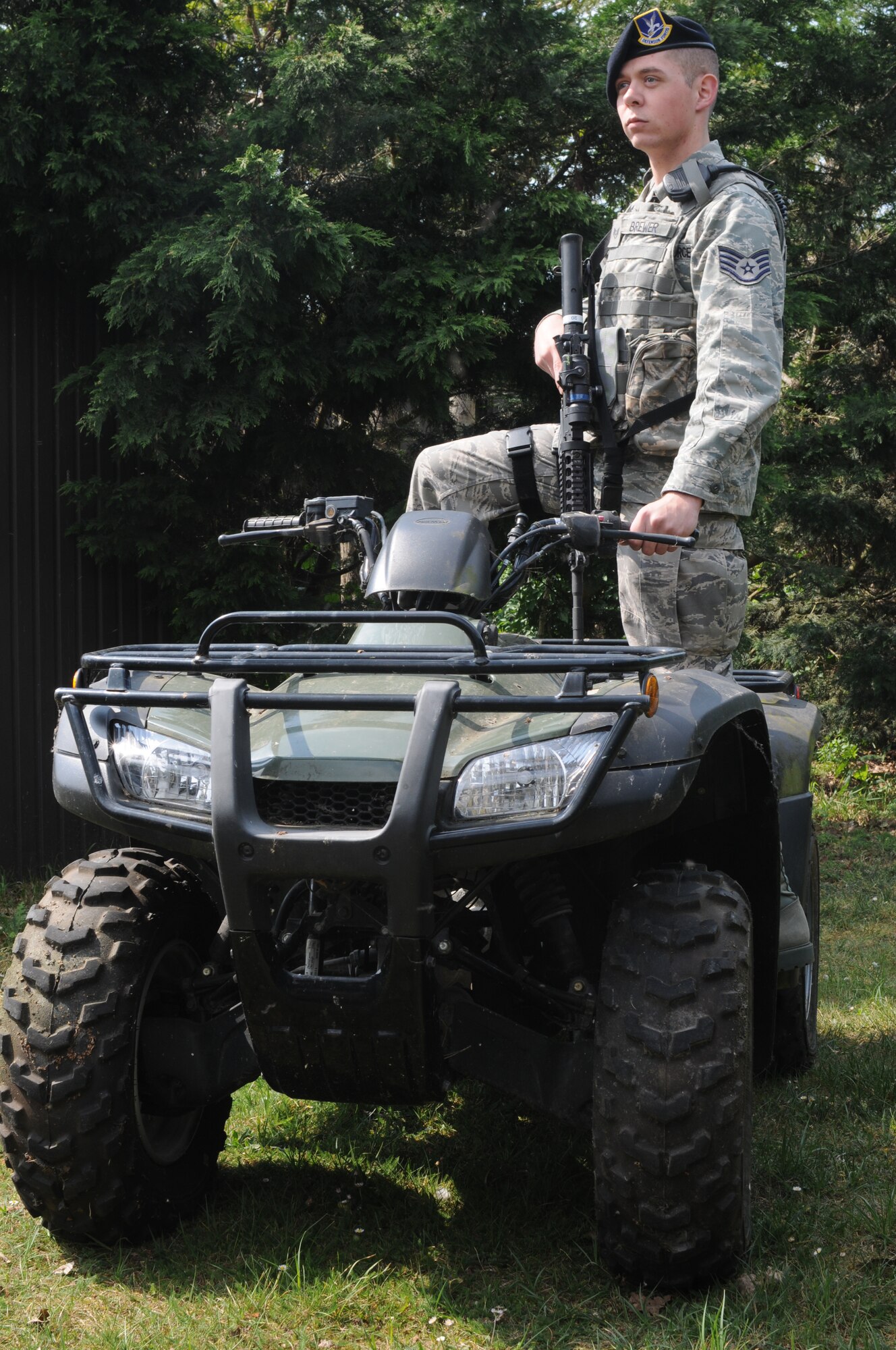 Staff Sgt. Trevor Brewer, 48th Security Forces Squadron NCO in charge of vehicles, inspects an area on an all-terrain vehicle April 28, 2011.  Sergeant Brewer was recently selected as the Air Force Colonel Billy Jack Carter award winner.  The award is presented annually to an Airman who plays a pivotal role in protecting Air Force members, assets and resources. (U.S. Air Force photo by Airman 1st Class Cory Payne)