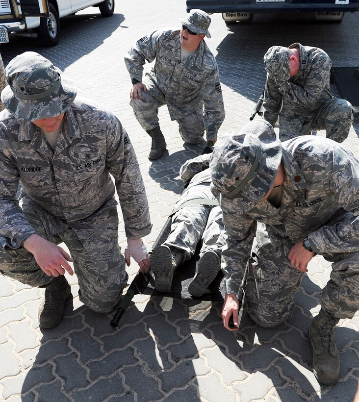 SOUTHWEST ASIA - Tech. Sgt. Shane Doxzon reviews litter-carrying procedures with Airmen from the 380th Expeditionary Medical Group as well as medics from the host nation air force Jan. 11, 2012. In addition to instruction on moving patients, both groups trained each other on loading people into their respective emergency vehicles. Doxzon, an Omaha, Neb., native, is the NCO in charge of medical services deployed from Offutt Air Force Base, Neb. (U.S. Air Force photo/Staff Sgt. J.G. Buzanowski)