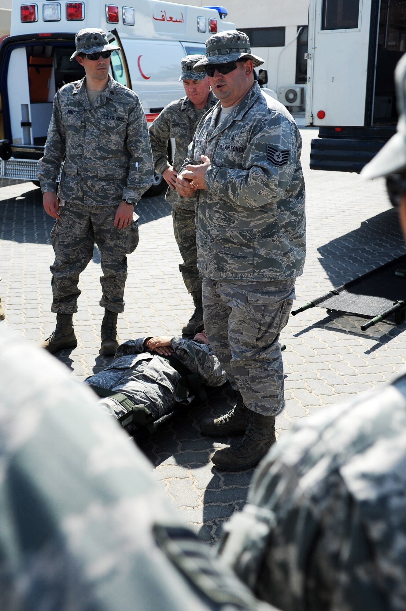 SOUTHWEST ASIA - Tech. Sgt. Shane Doxzon reviews litter-carrying procedures with Airmen from the 380th Expeditionary Medical Group as well as medics from the host nation air force Jan. 11, 2012. In addition to instruction on moving patients, both groups trained each other on loading people into their respective emergency vehicles. Doxzon, an Omaha, Neb., native, is the NCO in charge of medical services deployed from Offutt Air Force Base, Neb. (U.S. Air Force photo/Staff Sgt. J.G. Buzanowski)