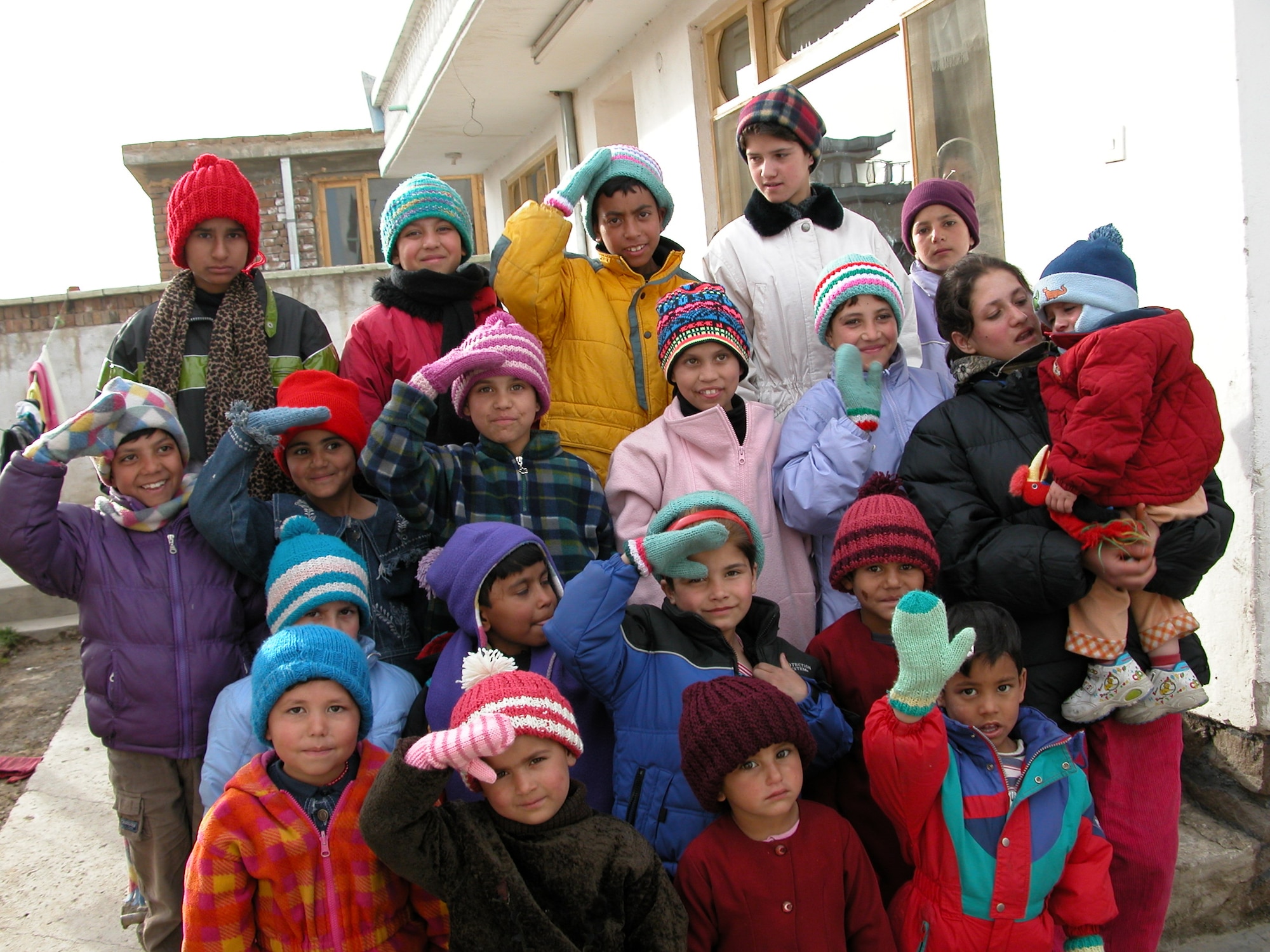 KANDAHAR AIRFIELD, Afghanistan --  A group of young girls at the Omid-e-mirmun orphanage in the Koshalkhan district of Kabul wave and salute to their supporters. The orphanage is supported by the Afghan Women's Organization. (Courtesy photo)