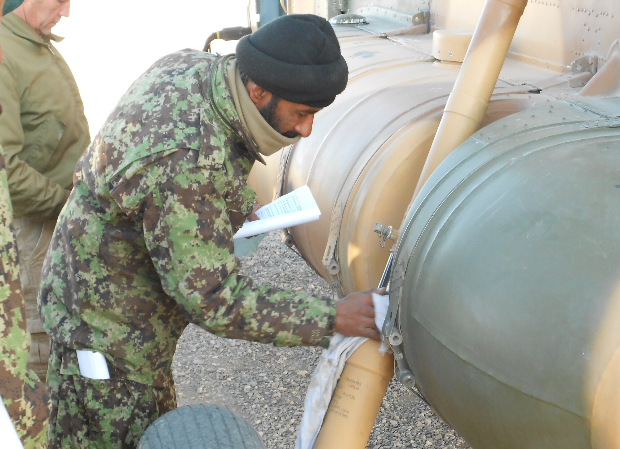 An Afghan air force maintenaner inspects a MI-17.(courtesy photo)
