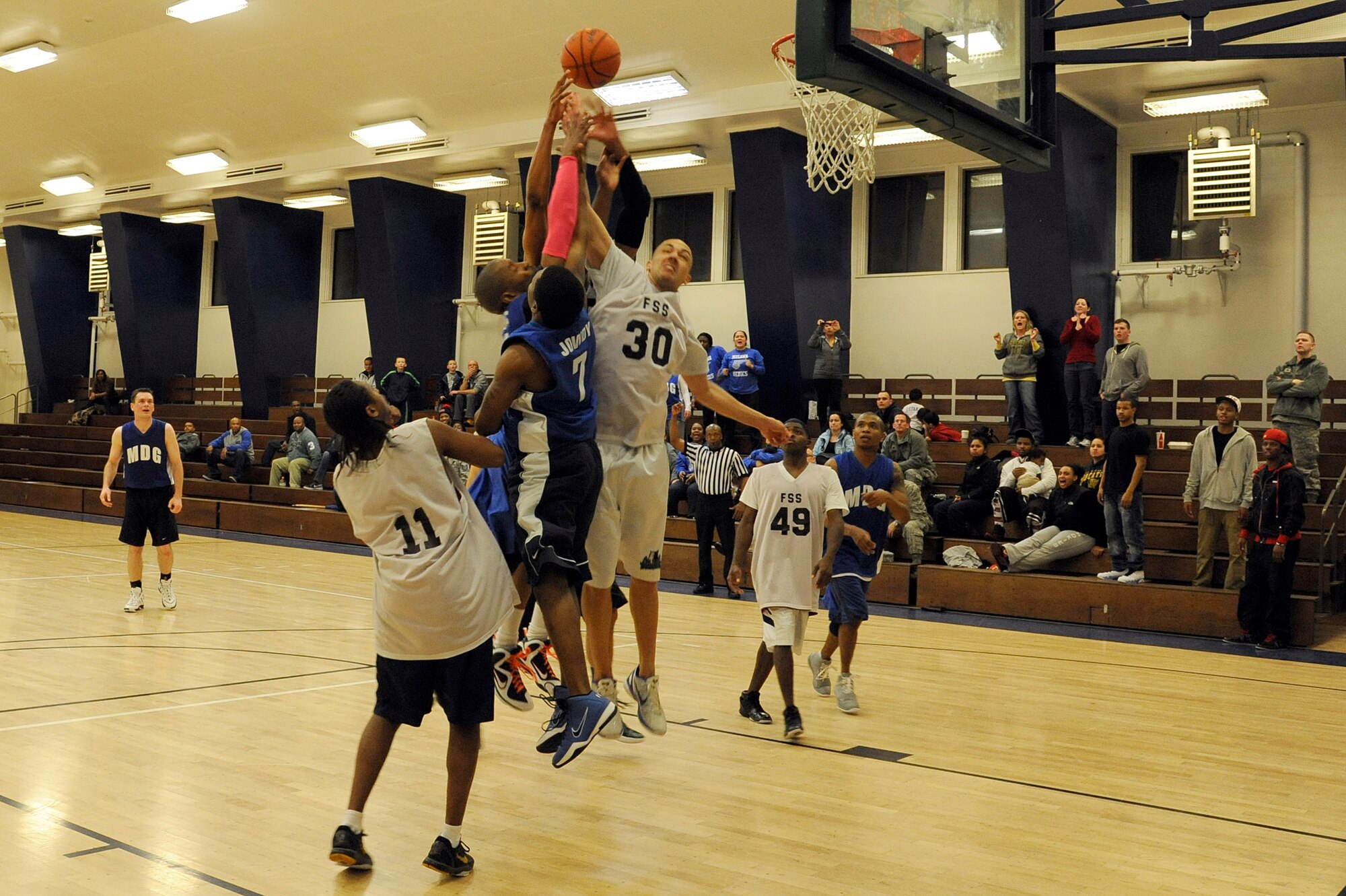 MISAWA AIR BASE, Japan - Members of the Misawa Security Operations Center and 35th Medical Group fight for the ball during the base intramural basketball championship game held at the Potter Fitness Center here, Jan. 11. The MSOC defeated the 35 MDG 55-49 during over-time of game two to take the base championship title. (U.S. Air Force photo/Tech. Sgt. Marie Brown)