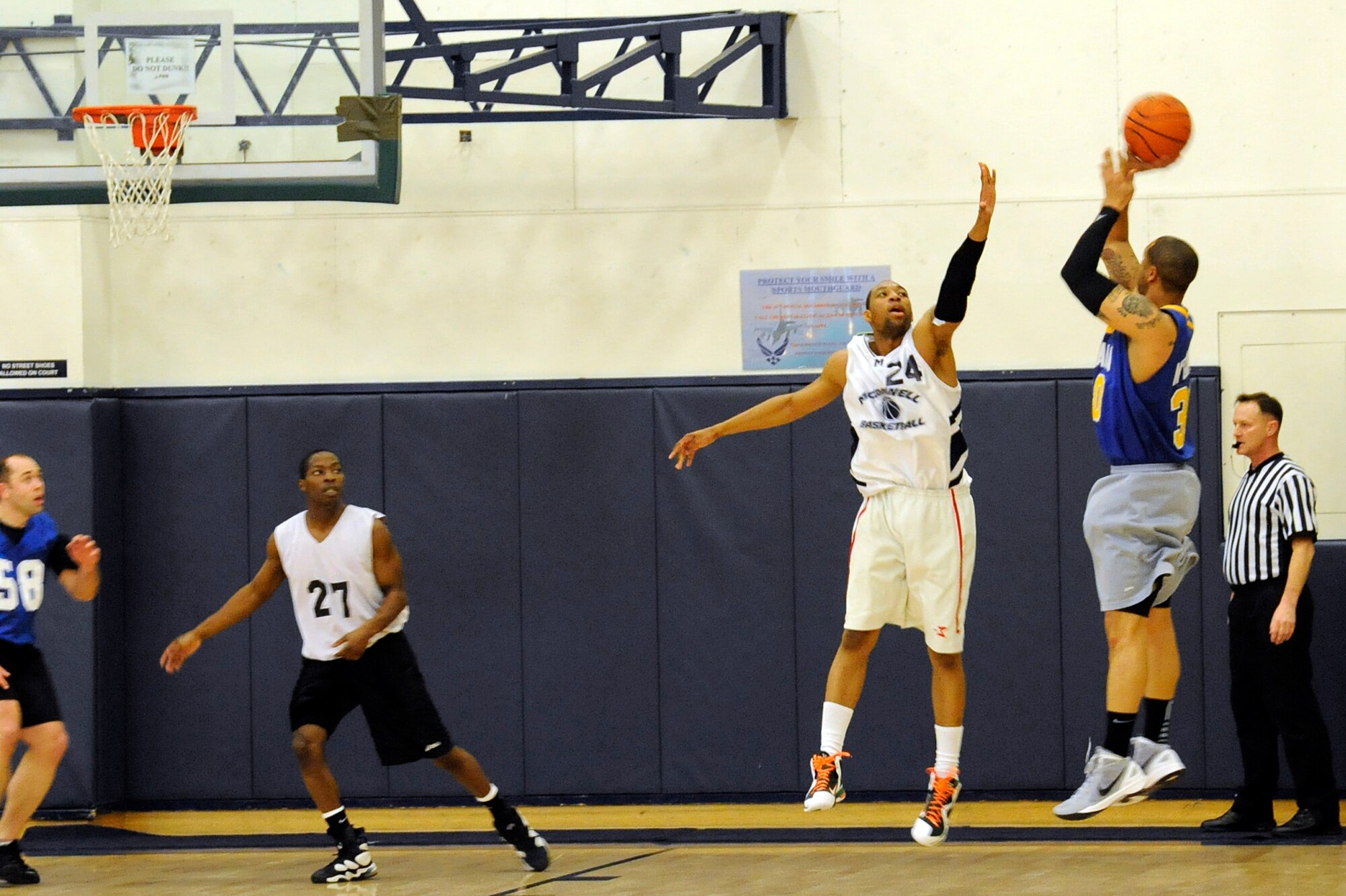 MISAWA AIR BASE, Japan - Dominique Barrett, left, Misawa Security Operations Center team member, prepares to block a shot from Adam Wilson, 35th Medical Group team member, during the base intramural basketball championship game held at the Potter Fitness Center here, Jan. 11. The MSOC defeated the 35 MDG 55-49 in game two of the double elimination tournament. (U.S. Air Force photo/Tech. Sgt. Marie Brown)