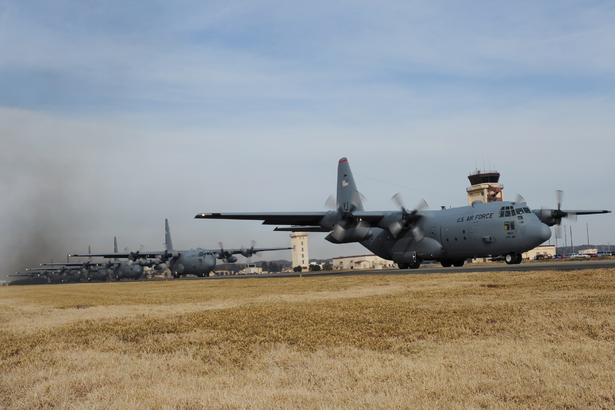 YOKOTA AIR BASE, Japan -- Six C-130 Hercules aircraft with the 36th Airlift Squadron taxi into position during a Samurai Surge formation flight at Yokota Air Base, Japan, Jan. 10, 2012. During the mission, 36th AS aircrews practiced a variety of airdrop techniques to include low-cost, low-altitude cargo drops and personnel airdrops. (U.S. Air Force photo/Capt. Raymond Geoffroy)