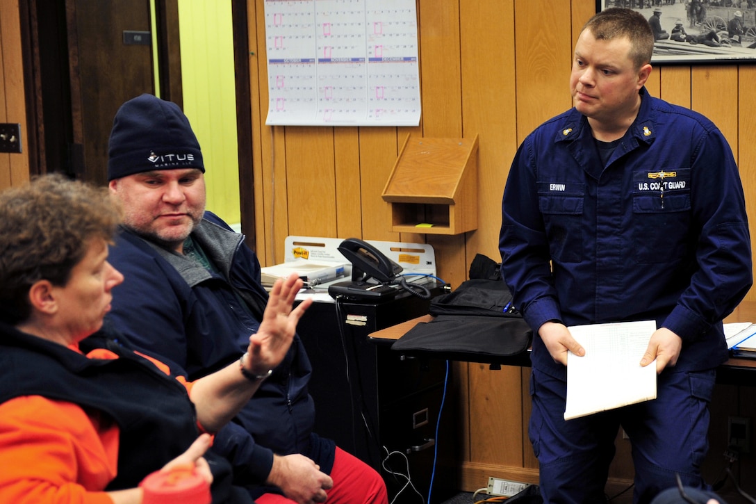 U.S. Coast Guard Chief Petty Officer Shawn Erwin, right, discusses the