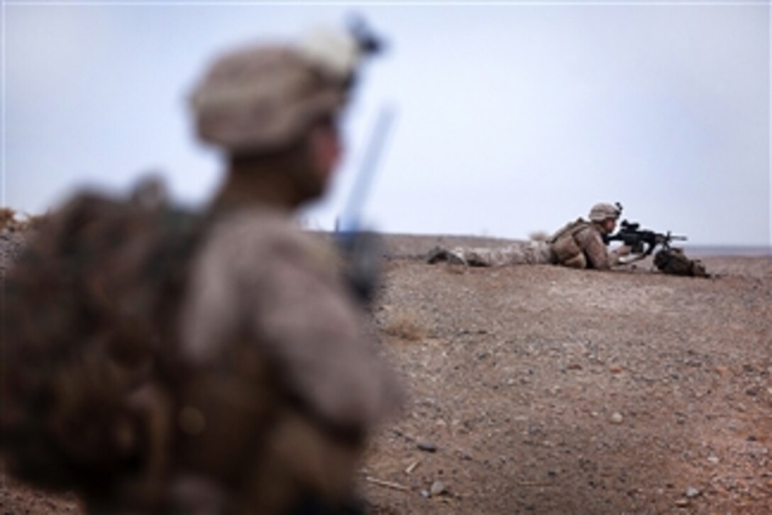 U.S. Marine Corps Lance Cpls. Joshua Prall (left) and Derrick Wastart (right) provide security while fellow U.S. Marines help Afghan soldiers clear a compound during Operation Tageer Shamal in Afghanistan's Helmand province on Jan. 4, 2012.  Prall and Wastart are riflemen assigned to Lima Company, 3rd Battalion, 3rd Marine Regiment.  