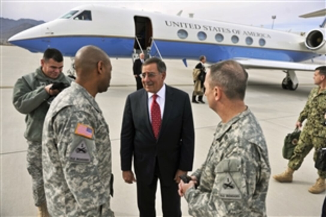 Defense Secretary Leon E. Panetta greets Army Maj. Gen. Dana J.H. Pittard, second from right,  as he arrives on Fort Bliss to visit troops and local dignitaries during a two-day stop near El Paso, Texas, Jan. 12, 2012. Pittard is the commanding general of the 1st Armored Division and Fort Bliss.