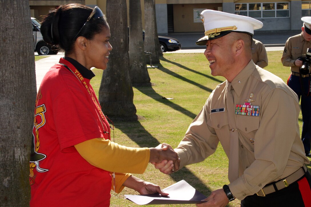 Kim Smith, a teacher at Robbinsdale-Cooper High School, accepts her Educators Workshop completion certificate from Brig. Gen. Daniel D. Yoo, Western Recruiting Region commanding general, before heading to the airport on Jan. 13. For additional imagery from the event, visit www.facebook.com/rstwincities.
