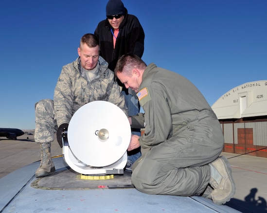 U.S. Air Force Senior Master Sgt. Skippy Littlefield and Chief Master Sgt. Douglas Whitney of the 169th Intelligence Squadron install a communications antenna on top of a C-130 while Ryan Moncur of Lockheed Martin observes at the Utah Air National Guard Base, Salt Lake City Utah, January 11, 2012. The 169th Intelligence squadron is outfitting the C-130 for an upcoming AFRICOM deployment.  (U.S. Air Force Photo by TSgt Jeremy Giacoletto-Stegall/Released)

