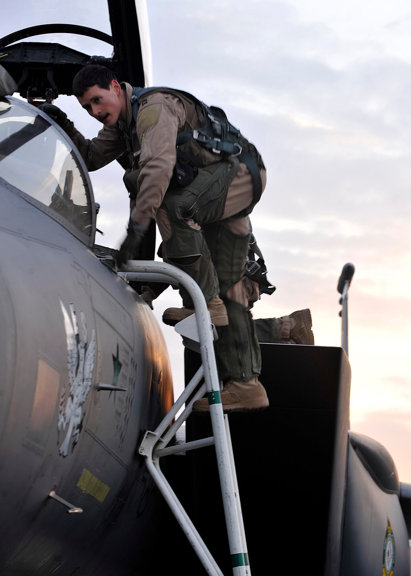 BAGRAM AIRFIELD, Afghanistan—Capt. Ryan Bodenheimer climbs into F-15E Strike Eagle #89-0487 before the mission that will bring it up to 10,000 logged flying hours at Bagram Airfield, Afghanistan, Jan. 13, 2012. Bodenheimer is an F-15E pilot with the 335th Expeditionary Fighter Squadron and is deployed from Seymour-Johnson Air Force Base, N.C. Bodenheimer was chosen to fly this historic landmark mission because he is one of the youngest pilots at the 335th. (U.S. Air Force photo/ Airman 1st Class Ericka Engblom)