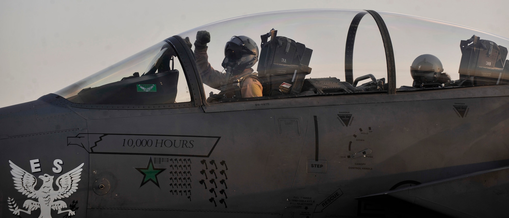 BAGRAM AIRFIELD, Afghanistan—Capt. Ryan Bodenheimer celebrates as he and Capt. Erin Short taxi onto the runway in F-15E Strike Eagle #89-0487 before the mission that will bring  its logged flying hours up to 10,000 at Bagram Airfield, Afghanistan, Jan. 13, 2012. Bodenheimer is an F-15E pilot with the 335th Expeditionary Fighter Squadron and is deployed from Seymour-Johnson Air Force Base, N.C. Short is a weapons system officer with the 335th Expeditionary Fighter Squadron and is also deployed from Seymour-Johnson Air Force Base, N.C. (U.S. Air Force photo/ Airman 1st Class Ericka Engblom)