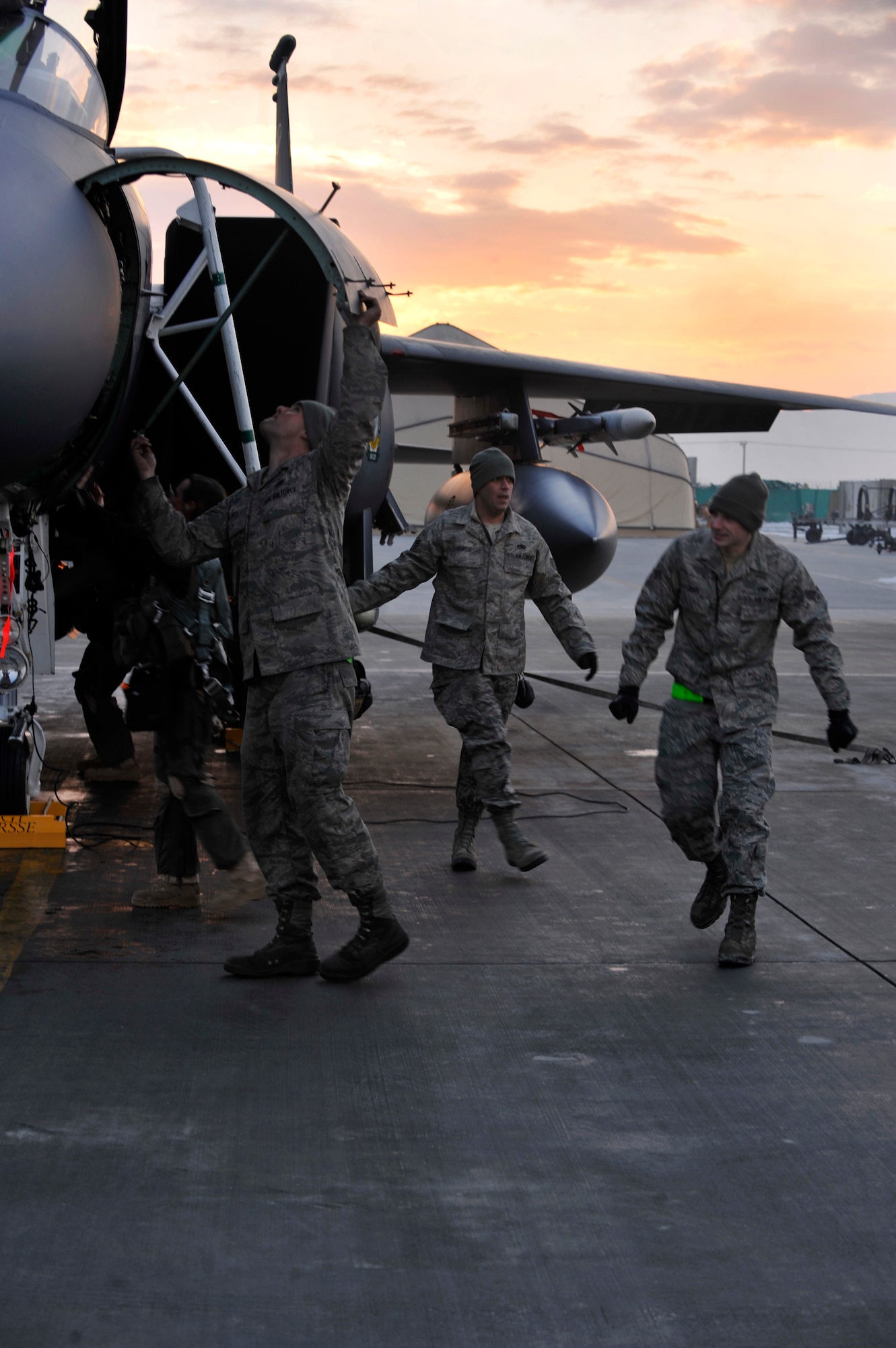 BAGRAM AIRFIELD, Afghanistan—Staff Sgt. Ryan Forsse, Senior Airman Eric Rock and Airman 1st Class Joshua Meints perform the final pre-flight maintenance inspection on F-15E Strike Eagle #89-0487 before it goes on the mission that will bring it’s flying hours up to 10,000 at Bagram Airfield, Afghanistan, Jan. 13, 2012. Forsse, Rock, and Meints are all crew chiefs with the 455th Expeditionary Aircraft Maintenance Squadron and are deployed from Seymour-Johnson Air Force Base, N.C. (U.S. Air Force photo/ Airman 1st Class Ericka Engblom)