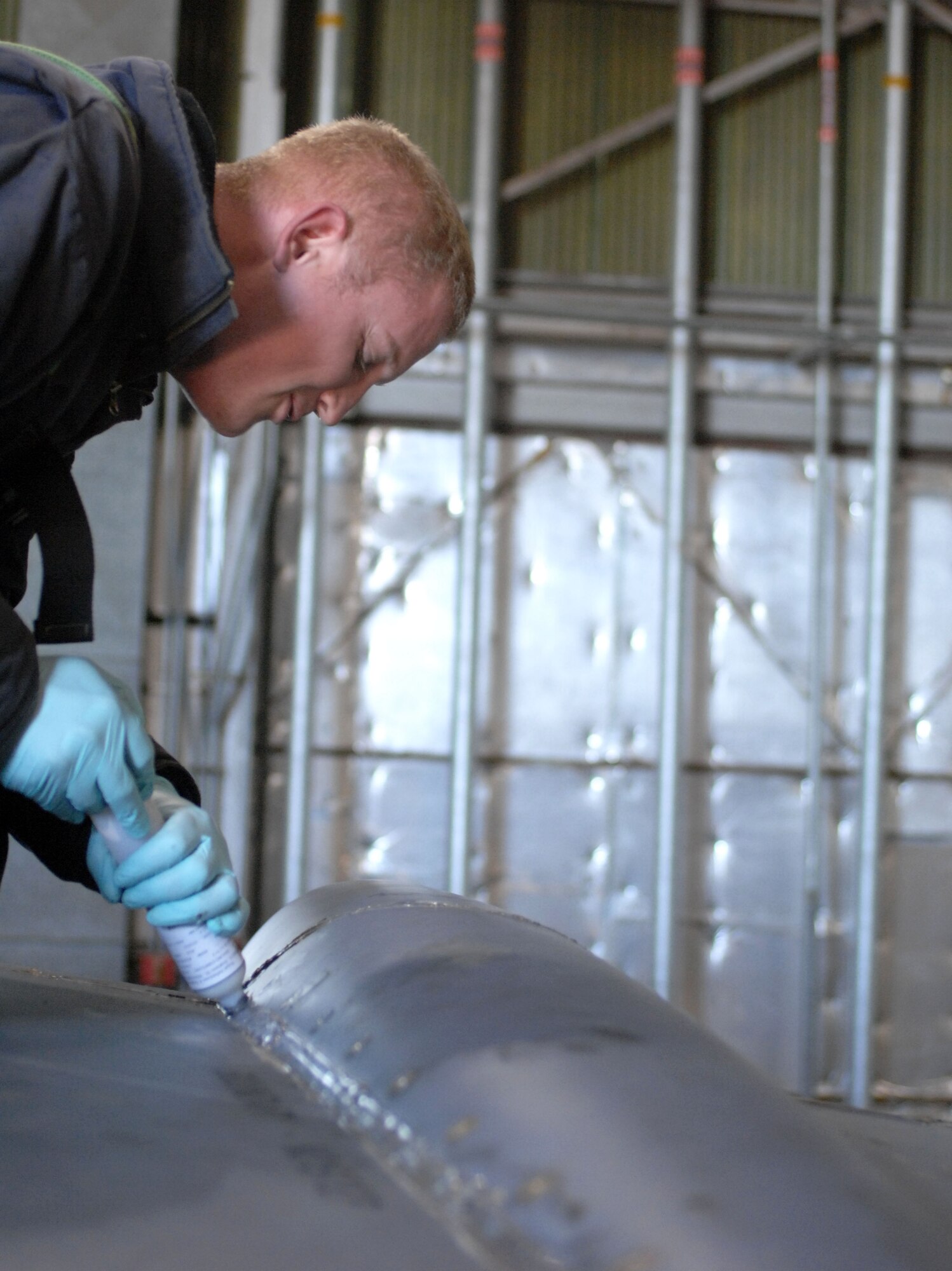 Staff Sgt. Joshua Engel, 96th Aircraft Maintenance Unit, applies a two-part sealant to the beaver tail panels on a B-52H Stratofortress on Barksdale Air Force Base, La., Jan. 12. Engel applied the sealant to the panels that were removed during inspection of the B-52. (U.S. Air Force photo/ Airman 1st Class Joseph A. Pagán Jr.)(RELEASED)