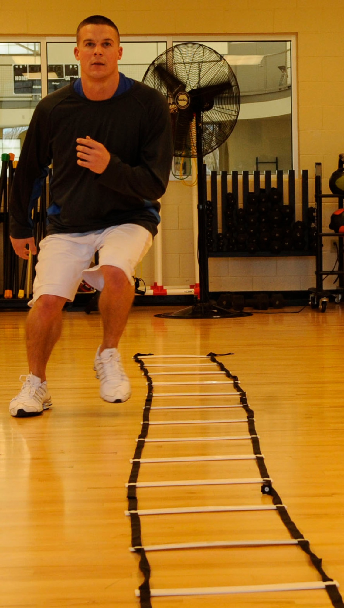 1st Lt. Ben Meighan, 2nd Medical Group, completes an agility exercise at the fitness center on Barksdale Air Force Base, La., Jan. 11. Health and Wellness Center fitness expert, Leah Beckham, trained Meighan on exercises she plans to implement in the new running improvement program. (U.S. Air Force photo/Airman 1st Class Andrea F. Liechti)(RELEASED)