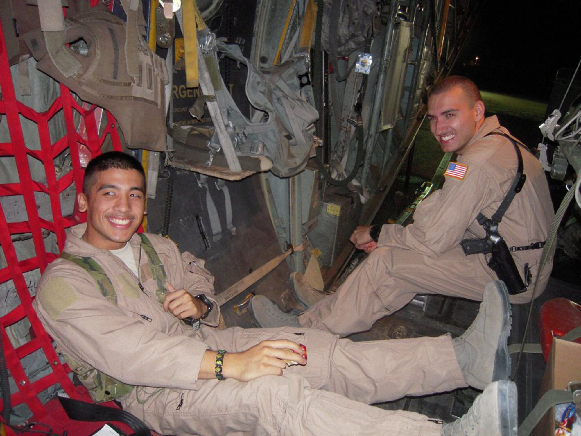 Senior Airmen Marcello Yamaguchi and Dylan Congrove await patients on board a C-130 medical evacuation mission in the Middle East in December.  Both are Air Force Reserve medical technicians with the 446th Aeromedical Evauation Squadron out of McChord Field, Wash. They are on their first deployment, both fulfilling their dream of serving their county. (Courtesy photo)