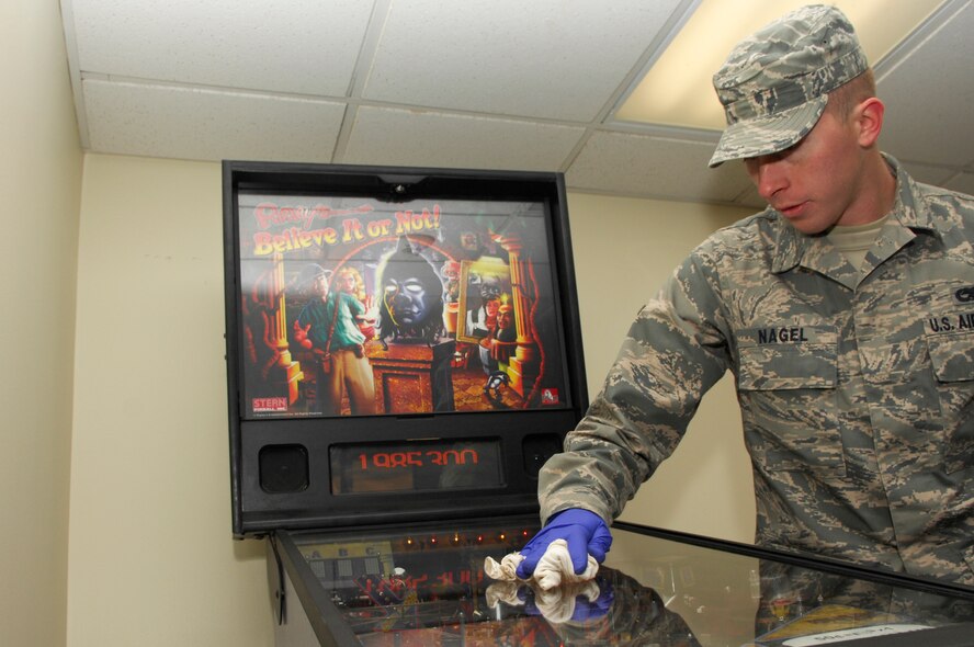 U.S. Air Force Airman Sean Nagel, 20th Aircraft Maintenance Squadron, cleans a gaming machine during bay orderly, Shaw Air Force Base, S.C., Jan.13, 2012. Bay orderly is a weeklong extra duty where dorm residents ensure their living quarters are clean and in inspection order. (U.S. Air Force photo by Airman 1st Class Ashley L. Gardner/Released)