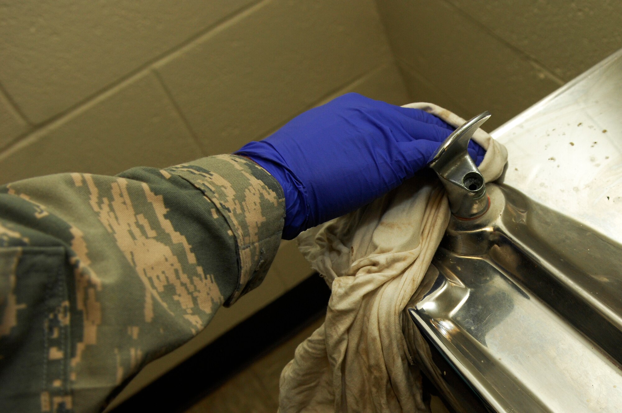 U.S. Air Force Airman Sean Nagel, 20th Aircraft Maintenance Squadron, cleans off the water fountain in the dormitory area for bay orderly, Shaw Air Force Base, S.C., Jan.13, 2012. Bay orderly is a weeklong extra duty where dorm residents ensure their living quarters are clean and in inspection order. (U.S. Air Force photo by Airman 1st Class Ashley L. Gardner/Released)

