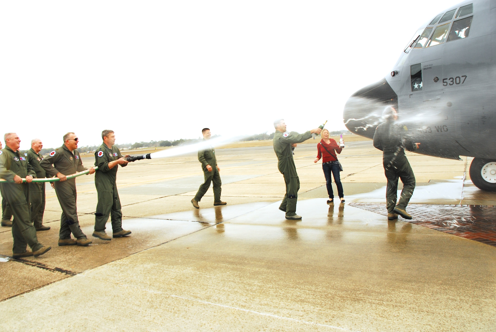 Lt. Col. Jason May, 53rd Weather Reconnaissance commander, gets hosed at the completion of his final flight as an Air Force Reservist  Jan. 7. May relinquished command of the squadron the same day and retired from the Air Force Reserve after serving over 30 years. (U.S. Air Force photo by Staff Sgt. Tabitha Dupas)