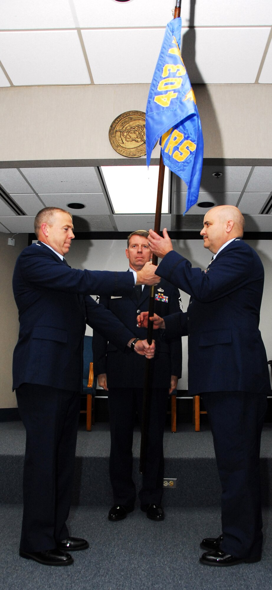 Lt. Col. Gregory Lufkin accepts command of the 53rd Weather Reconnaissance Squadron from Lt. Col. Robert Stanton, 403rd Operations Group commander, during the change of command ceremony Jan. 7. The squadron's previous commander, Lt. Col. Jason May, retired from the Air Force Reserve after serving over 30 years. (U.S. Air Force photo by Staff Sgt. Tabitha Dupas)
