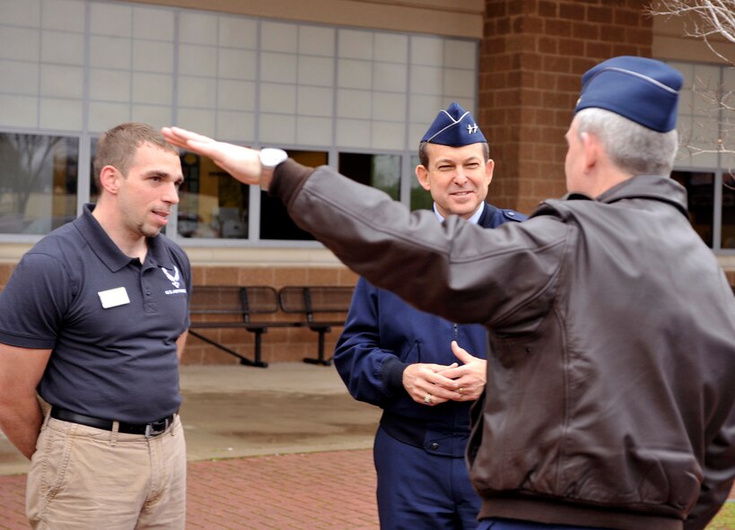 Col. Tim Fay, 2nd Bomb Wing commander, motions to the newly renovated sports field as he speaks to Maj. Gen. Timothy Byers, Installation Excellence Selection Board team leader, and Michael Kaplan, fitness center director, in front of the fitness center on Barksdale Air Force Base, La., Jan. 9. The Installation Excellence Award is an annual award that recognizes the outstanding efforts of people who operate and maintain Department of Defense installations, and effectively use their resources to support the mission. (U.S. Air Force photo/Senior Airman Chad Warren)(RELEASED)