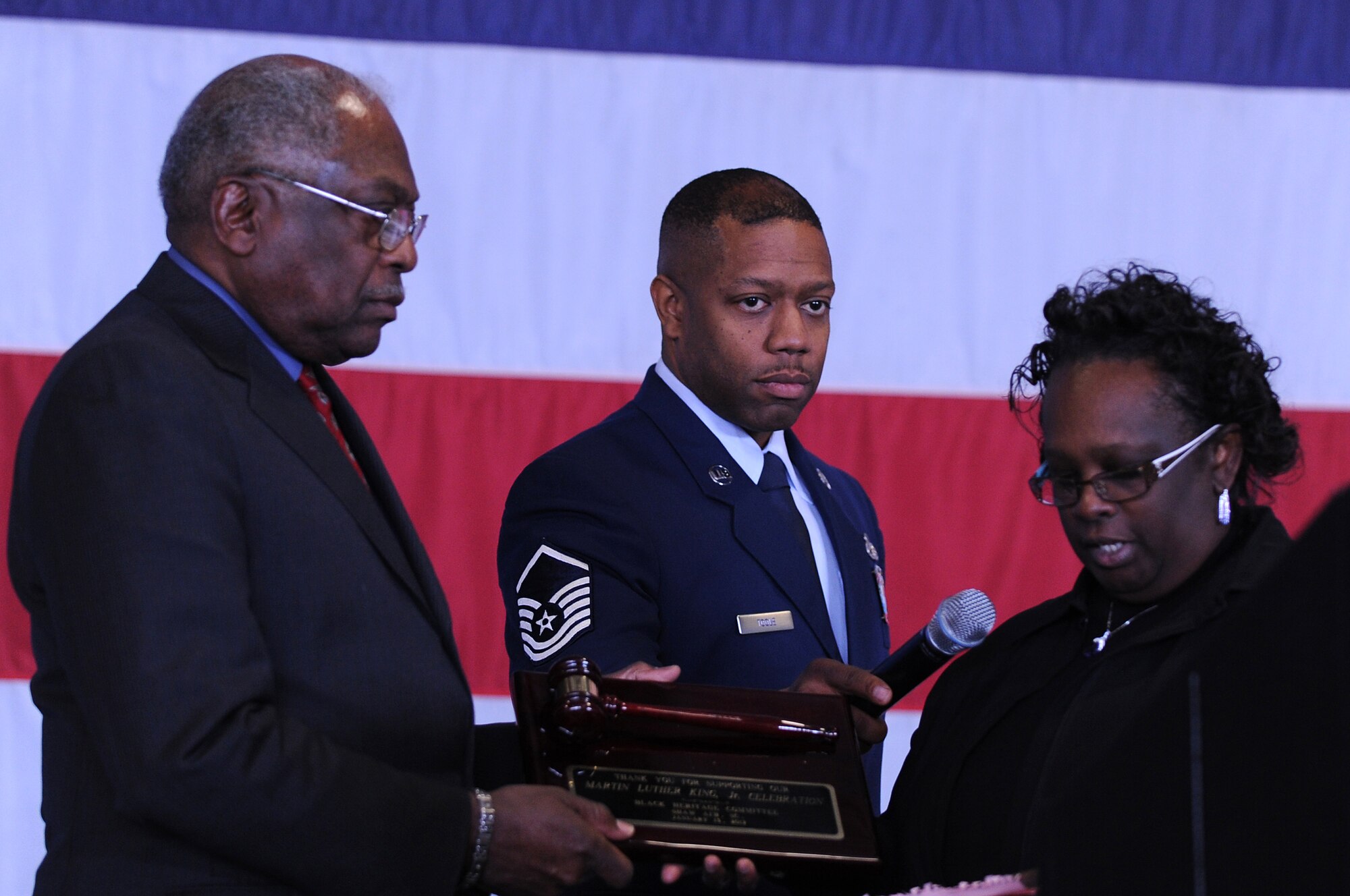 Willa Pembleton presents a gift of appreciation to Congressman James E. Clyburn with an award for his support at the Martin Luther King Jr. Luncheon at Shaw Air Force Base, S.C., Jan. 13, 2011. The luncheon is an annual event held to celebrate and remember King, and the impact he had on the United States of America. (U.S. Air Force photo by Airman 1st Class Hunter Brady/Released)