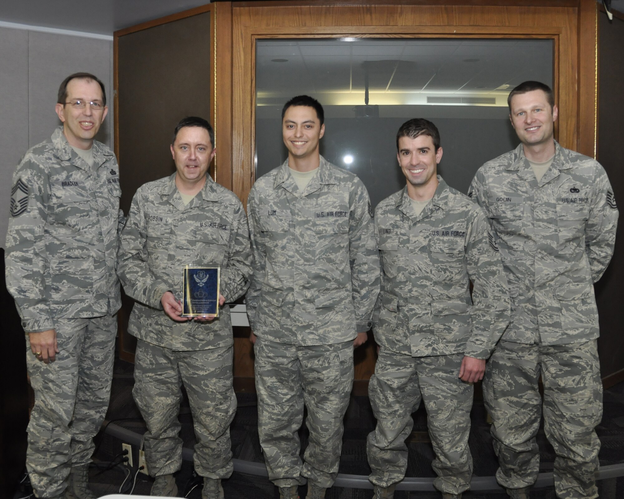 The members of the 302nd Airlift Wing Operations Support Flight Intel Shop were named the Air Force Reserve Command’s Outstanding Operations Group Intel/Operations Support Flight Intelligence, Surveillance and Reconnaissance Unit of the Year for 2010. “The 302nd Intel shop provided invaluable intelligence to mission crews across the spectrum of the Air Force,” said Chief Master Sgt. Doug Bradley, Chief Enlisted Manager, Intelligence Headquarters Air Force Reserve Command. Picture from left to right; Chief Master Sgt. Doug Bradley, Master Sgt. David Robbin, Staff Sgt. Christian Lum, Tech. Sgts Jonathan Lind and Jason Gouin. (U.S. Air Force photo/Tech. Sgt. Peter Dean)